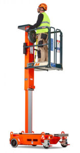 Man standing on lift platform, ready to work at construction site.