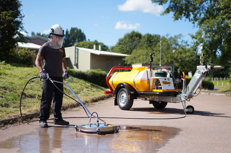 Cleaning road with Bowser pressure washer