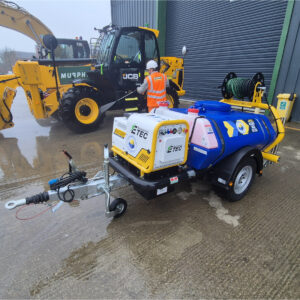 Hireman branded Boweser pressure washer being operated to clean a digger.